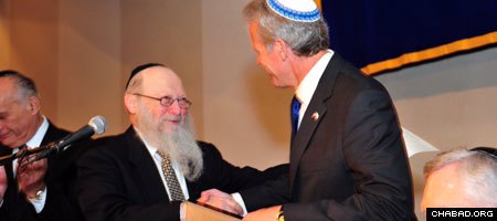 Israeli Ambassador to the U.S. Michael B. Oren receives an honorary law degree from Chabad-Lubavitch Rabbi Moshe Herson, dean of the Rabbinical College of America, at the institutions 40th anniversary dinner in Newark, N.J. (Photo: Michael Livshin)