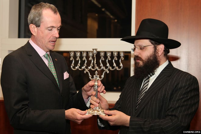 U.S. Ambassador Philip D. Murphy received a menorah from Chabad-Lubavitch Rabbi Yehuda Tiechtel at a reception honoring the public menorah lighting at Berlin’s Brandenburg Gate.