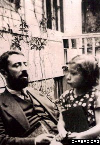 A young Chana Sharfstein sits on the lap of her father, Rabbi Yaakov Yisroel Zuber.