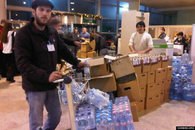 After hail and ice forced the cancellation of hundreds of flights from Moscow’s Domodedovo Airport and stranded thousands of passengers, a group of volunteers from the local Jewish community started passing out bottled water and food.