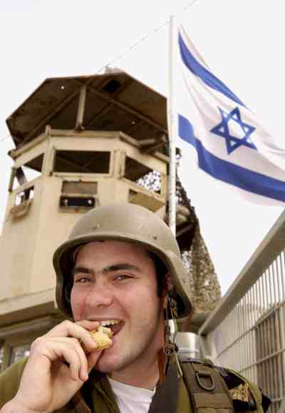 Soldier eating Hamantash.jpg