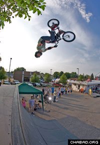 A Rise Above BMX team member performs a 360-degree back flip.