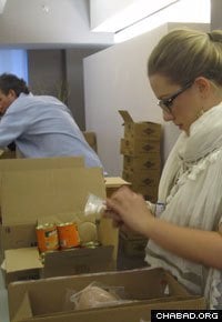 The boxes of food include canned fruits and vegetables, and other sundry items.