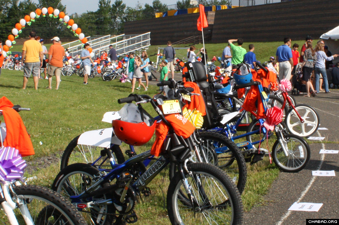 Volunteers line up a fleet of specially-designed bicycles to be given to 100 local children with special needs as part of Olivia’s Friendship Cycle.