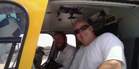 Eric also flies a helicopter to save lives. Eric and Eli enjoying a moment aboard a rescue chopper.