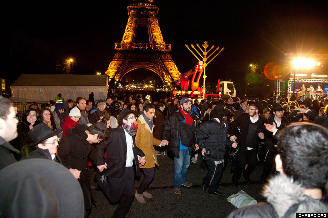 Thousands of revelers danced in the streets after the giant Chanukah menorah was lit at the Eiffel Tower.