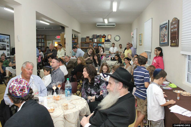 More than 125 Jewish residents and tourists pack Chabad-Lubavitch of Puerto Rico for the arrival and dedication of its third Torah scroll.