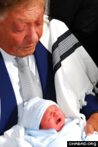 Sami Rohr receives the highest honor, sandek, at the 2009 circumcision of his great-grandson Avraham Zvi Sragowicz, at The Shul of Bal Harbour, Surfside, Fla.