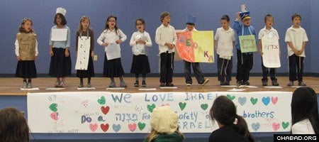 Students at Chabad's Torah Day School of Houston assembled to explain the mitzvahs they chose to help the safety and security of Israel.