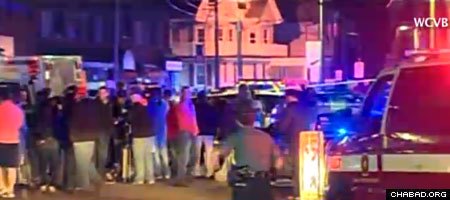 Onlookers of the Thursday-night police standoff in Watertown, Mass., where one alleged suspect in the Boston Marathon explosions was shot dead, and one police officer killed and another wounded. The suspect's brother remained on the loose, causing a lockdown throughout the Boston area on Friday.