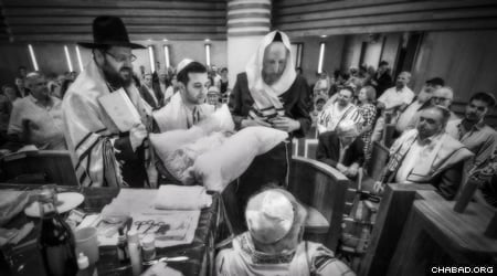A circumcision ceremony with Rabbi Yehuda Tiechtel, Rabbi of the Jewish community in Berlin, Germany. (Photo: Clifford Lester)