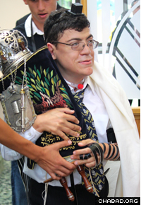 Andrew Lindhardt carried the Torah through the synagogue for the congregants to touch or kiss.