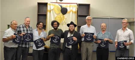At the cermony, Rabbi Shmuly Hecht, center, honored community members who had bought a pair of tefillin (phylacteries) since Hecht arrived in Kelowna. Each received a blue tallit bag with their names inscribed in Hebrew on the outside.