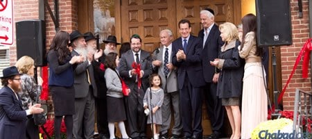 Rabbi Shua Rosenstein, center, cuts the ribbon at the dedication ceremony for the new Chabad on Campus center at Yale University. (Photo: Studio99Productions.com)