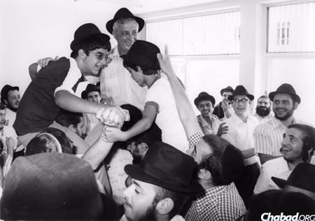 Ariel Sharon dances with his sons Omri, left, and Gilad, at Omri&#39;s bar mitzvah in Kfar Chabad.