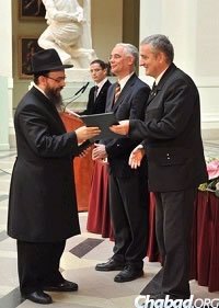 In 2012, Hungary’s Minister of Human Resources Zoltan Balog, right, presented Rabbi Baruch Oberlander with Hungary’s highest state honor, the Order of Merit.