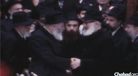 The Rebbe greets Rabbi Joseph B. Soloveitchik, who joined in the Yud Shevat farbrengen in 1980 in celebration of the Rebbe's 30th year of leadership. (Photo: Jewish Educational Media)