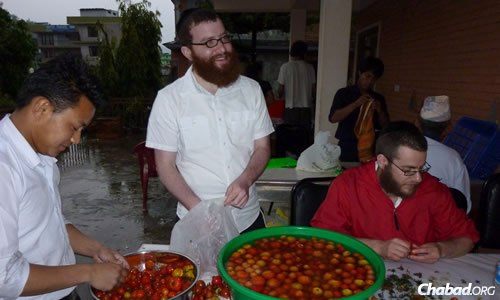 For rabbinical students like Shmuli Levitin, center, standing and Shmuel Loebenstein, seated, the preparations themselves are a enriching experience. (File photo: Chabad of Nepal)