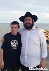 Rabbi Sholom Gopin with a local Jewish youth during more peaceful times