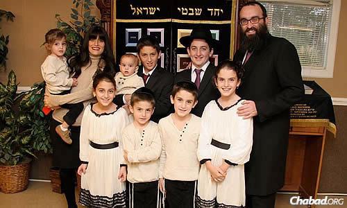 The family of Rabbi Hirshy and Rashi Minkowicz of Chabad of North Fulton, in Alpharetta, Ga. Their oldest son, Mendel, to the rabbi&#39;s left, is helping with a new building campaign for their Chabad House in honor of his late mother.
