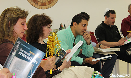 Local residents and visitors participate in a Megillah reading at Purim time.