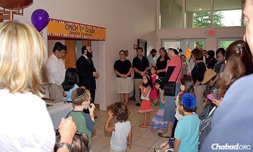 Chabad of Georgia associate director Rabbi Isser New speaks with students and parents of the Chaya Mushka Children's House (CMCH) in 2010, the year the first- through sixth-grade Montessori-style elementary school first started.
