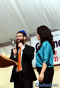 Rabbi Yosef and Chani Konikov addressed the audience at last month's groundbreaking event. (Photo: Sonacity Productions)