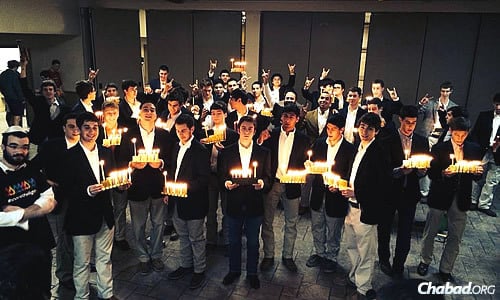 Students at the University of Texasin Austin hold Chanukah lights given out by Rabbi Zev Johnson, co-director of the Rohr Chabad Jewish Student Center there.