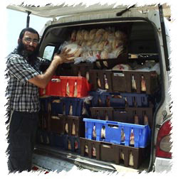 A Colel Chabad employee loads a van with Pitas, to deliver to those that are stranded in their homes in Safed, with all stores closed and not where to purchase basic necessities