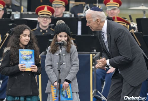 The vice president congratulates Basya Fogelman, left, and Simmy Hershkop after they read from their award-winning essays on what Chanukah means to them. (Photo: Ron Sachs)