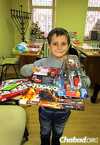 A boy in the after-school program at the Jewish community center in Mariupol receives a toy for Chanukah.