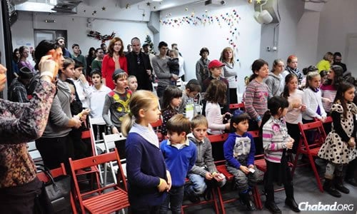 Children visit a science museum in Kiev as part of a Chanukah event for Donetsk Jews; here, they watch a menorah-lighting.