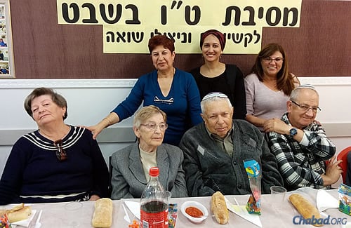 Holocaust survivors and seniors, accompanied by doting staff, participate in a Tu B&#39;Shevat event in Lod, Israel, sponsored by the Chabad-affiliated organization Yad BeYad. (Photo: M. Mamin)