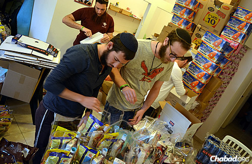 Packing up food gifts to be sent to “lone soldiers” in the Israeli Defense Forces, as part of this year&#39;s Purim project run by the Chayal el Chayal (“Soldier to Soldier”) organization.