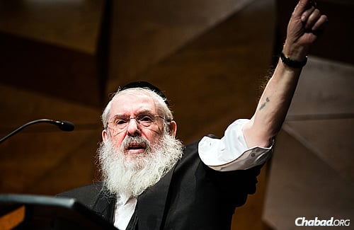 The rabbi displays the number tattooed on his arm; he was the youngest child inmate of Auschwitz. (Photo: Eliott Foust)