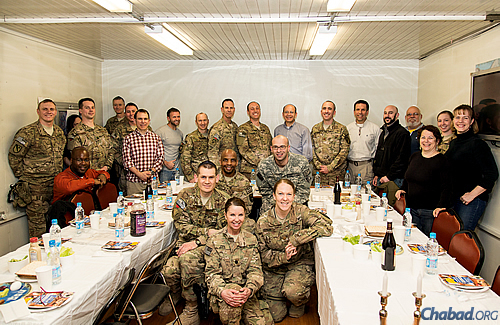 A group of servicemen and women get ready for a Passover seder. Shmurah matzah, Haggadahs, grape juice and the necessary items on the seder plate were shipped to them by the Aleph Institute. (Photo: The Aleph Institute)