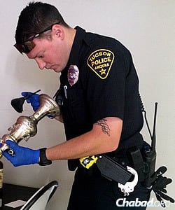 A police officer inventories some of the discovered items.
