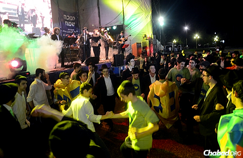 Boys dance to music at a celebratory bash this past Chanukah, which marked 30 years since the first public menorah was put up and lit in Argentina, initiated by Rabbi Grunblatt.
