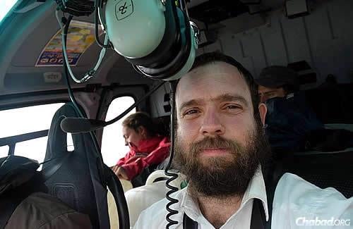 Rabbi Chezky Lifshitz—co-director of Chabad of Nepal with his wife, Chani—took to the skies himself in a Nepali government helicopter to reach the stranded. (Photos: Chabad.org/Nepal)