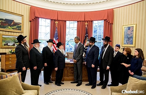 President Barack Obama presents a ceremonial copy of the “Education and Sharing Day, U.S.A.” proclamation that he issued on March 31, 2015 to a delegation of Chabad-Lubavitch emissaries and educators from around the country. (Official White House Photo: Pete Souza)