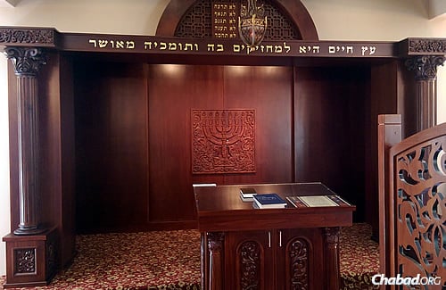 Warm tones and richly carved furnishings bring to mind traditional European synagogues.