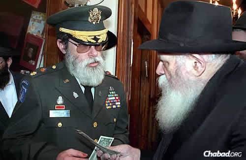 Getting a dollar from the Rebbe in December 1990, shortly before the first Gulf war. (JEM Photo)