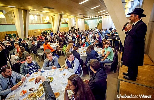 Rabbi Lazar addresses students at a meal in Paris during the first leg of the trip. (Photo: Eli Itkin)