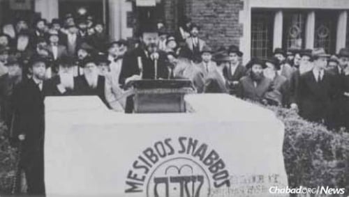 Rabbi Klein is in the background, center right, at an early Mesibos Shabbos rally.