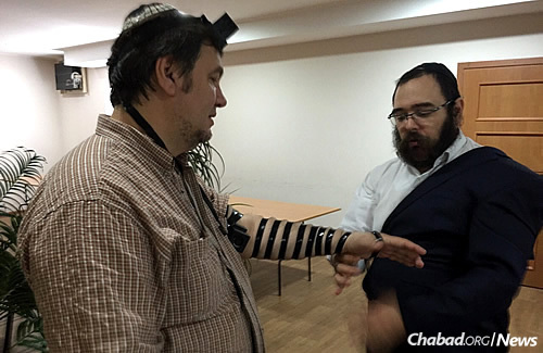 Although the elderly have mostly remained in the war-torn regions, some younger people have stayed, like this man wrapping tefillin with Rabbi Shalom Gopin. The city’s rabbi and Chabad-Lubavitch emissary returned home last week for the first time since war caused him to leave out a year ago.