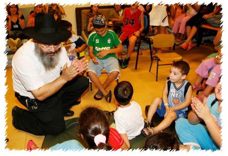 The “shelter brigades.” A Chabad-Lubavitch emissary encourages children in a bomb shelter in the northern town of Nahariya