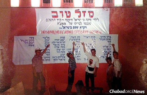 Five boys point to their new Jewish names on a “Mazal Tov” sign celebrating circumcisions in Moscow in 1992. Altogether, there are 54 names on the list—boys who reclaimed the heritage denied to them for generations.