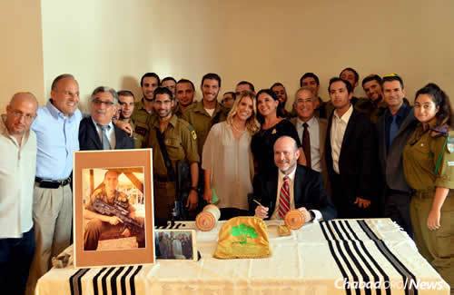 A Torah in memory of Max Steinberg, an American lone soldier killed last summer during Israel&#39;s war with Hamas in Gaza, was dedicated on July 12 in Jerusalem in the presence of family, friends and members of his company from the Golani 13 brigade. (Photo: Lone Soldier Center)