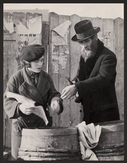 A man purchases herring for Shabbat in Mukacevo. (photo: Roman Vishniac)