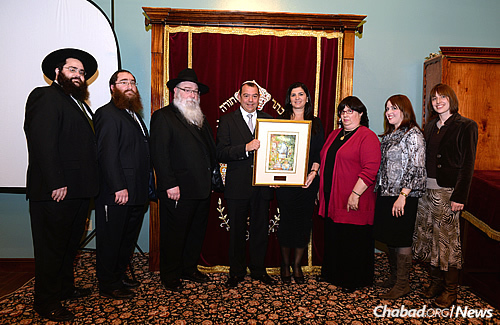 The dedication of the Btesh Family Chabad House in New Orleans, which was the first Chabad structure renovated after the hurricane. Pictured are three Rivkin families with Isaac and Bety Btesh.